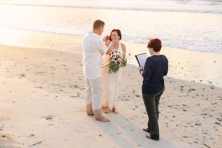 An elopement on the beach near Charleston, South Carolina. This wedding photo shows the couple right before their first kiss! 