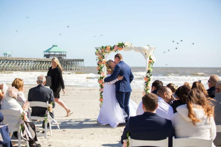 couple celebrating their wedding in folly beach, north carolina